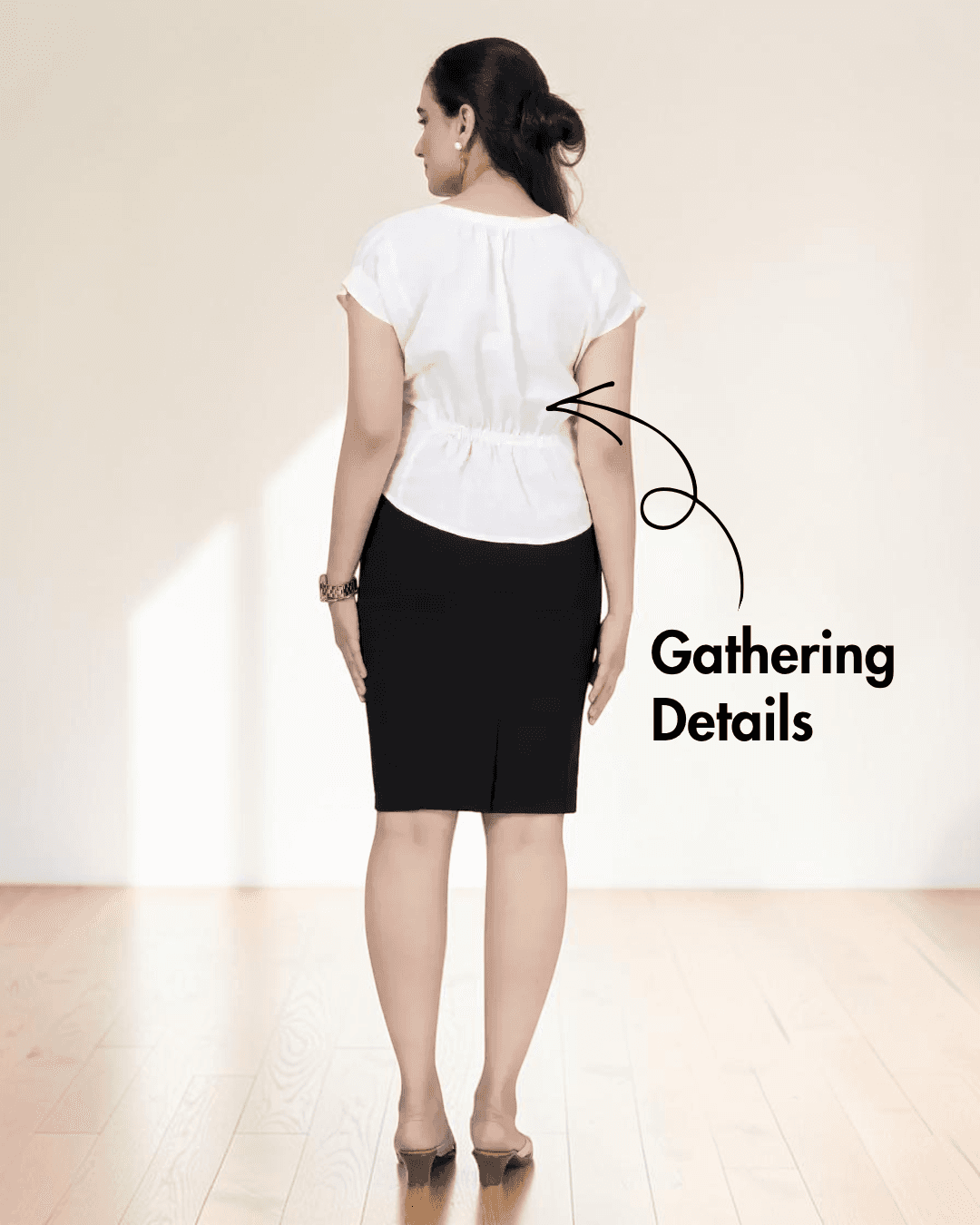 Back view of women's white short sleeve blouse sewing pattern with gathering at back