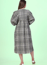 Back view of a model wearing a midi dress, featuring long sleeves and a seamless finish.