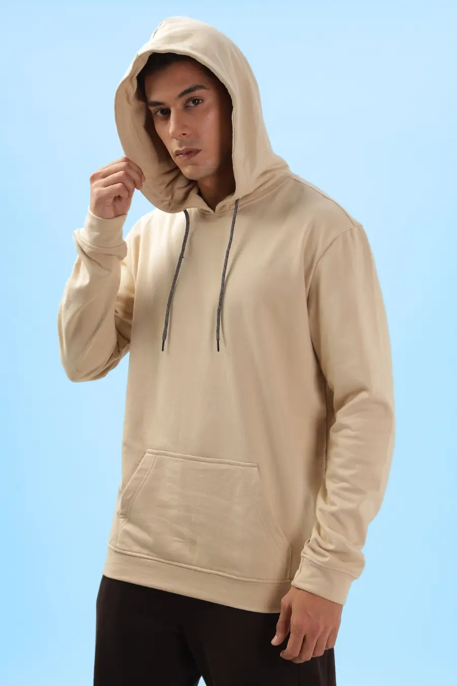 Men's hoodie with hood up, made using the 'Atlas' sewing pattern. Features a relaxed fit, drawstring hood, and kangaroo pocket for a cozy design.