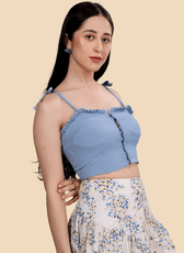 Close-up of the Piper strappy bustier top with ruffle details and button front. A stylish DIY sewing pattern for a feminine crop top.