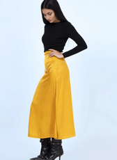 Side view of a mustard yellow A-line skirt made using the 'Marigold' sewing pattern. A flattering high-waist design with a smooth finish.