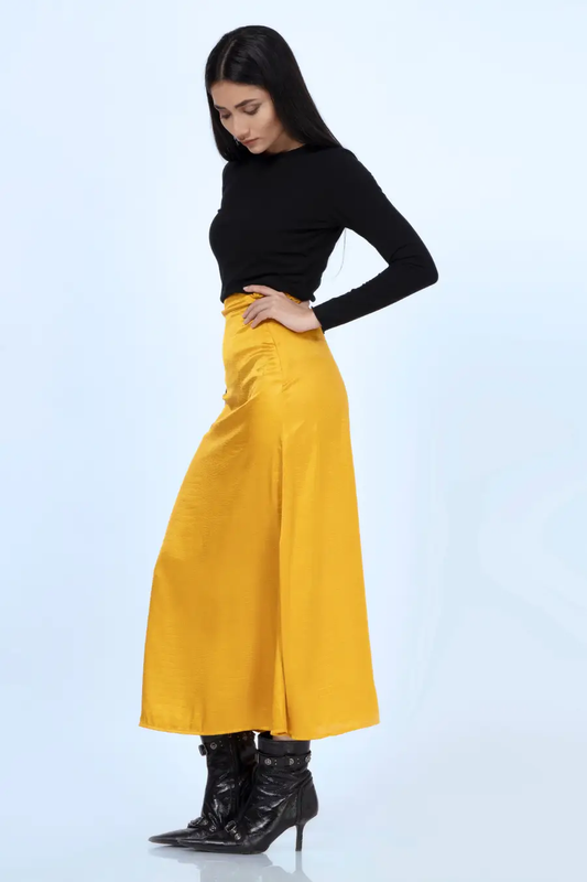 Side view of a mustard yellow A-line skirt made using the 'Marigold' sewing pattern. A flattering high-waist design with a smooth finish.