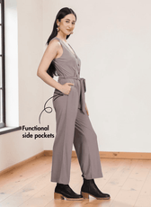 Close-up of taupe jumpsuit showing button-down front, V-neckline, and pattern details, side view