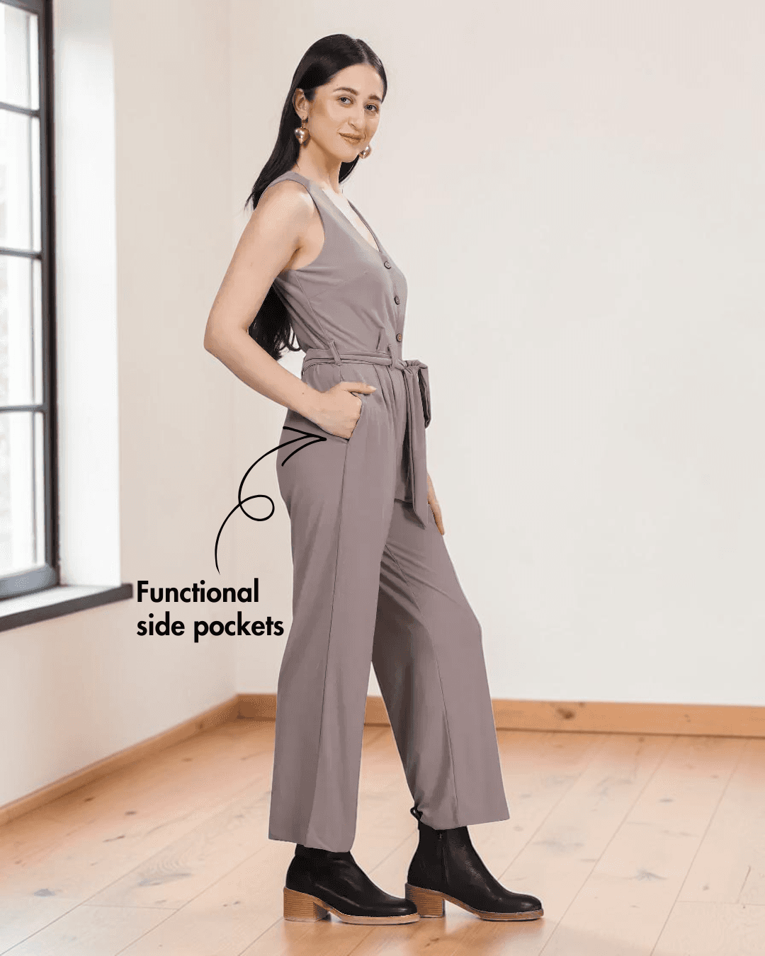 Close-up of taupe jumpsuit showing button-down front, V-neckline, and pattern details, side view
