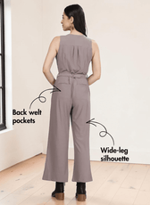 Close-up of taupe jumpsuit showing button-down front, V-neckline, and pattern details, back view