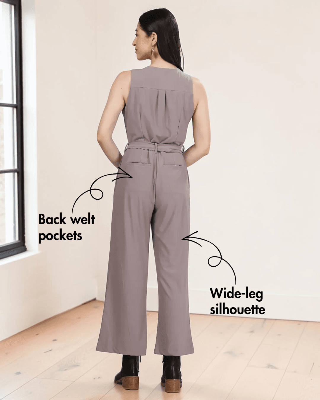 Close-up of taupe jumpsuit showing button-down front, V-neckline, and pattern details, back view