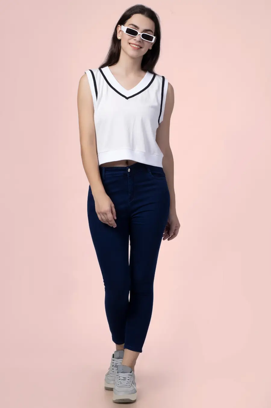 Model wearing the 'Nadine' sweater vest, a sleeveless V-neck top with contrast trim. A stylish and sporty sewing pattern for DIY fashion enthusiasts.