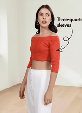 Close-up of woman in off-the-shoulder crop top with three-quarter sleeves, fashion style