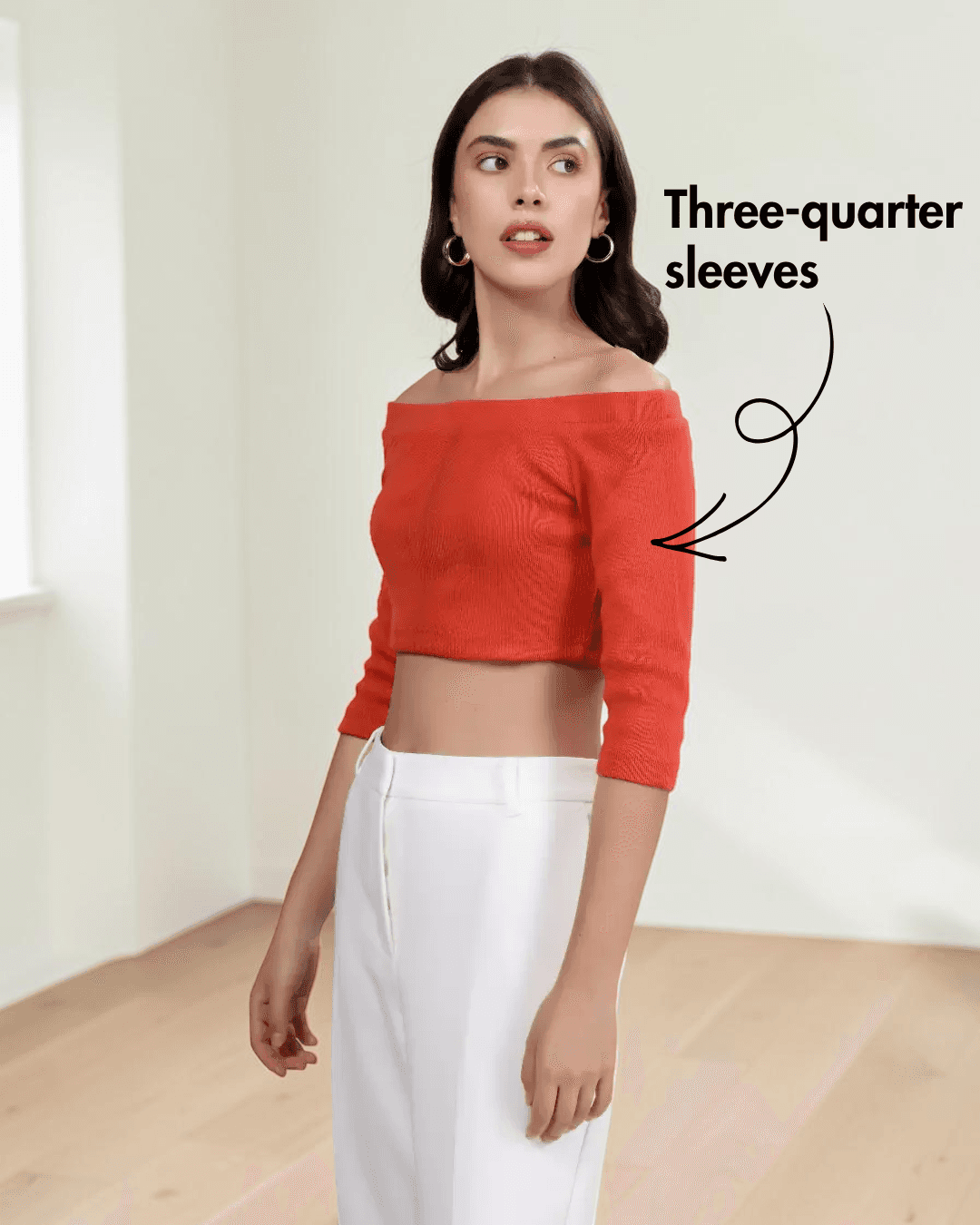 Close-up of woman in off-the-shoulder crop top with three-quarter sleeves, fashion style