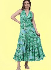 Model wearing a green halter neck maxi dress with a tiered skirt, made using Winslet's sewing pattern. Elegant and flowy design for various occasions.