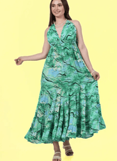 Woman in a green halter maxi dress showcasing the loose and flowy fit. Sewing pattern available in multiple sizes with digital download options.