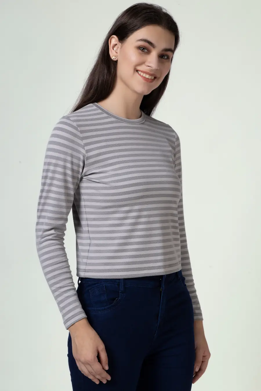 Model smiling while wearing a striped long sleeve t-shirt sewn from the 'Misha' pattern. A comfortable and stylish top for various occasions.