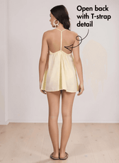 Back view of yellow halter beach dress showing open back with T-strap detail