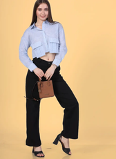 Model styling the Juniper Utility Shirt with a handbag, highlighting its fashionable cropped fit. A practical and stylish sewing pattern for DIY enthusiasts.