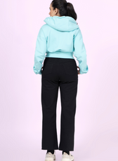 Back view of the 'Rue' zip-up hoodie sewing pattern. Features a cropped fit, ribbed waistband, and a cozy hood for a comfortable and stylish design.