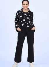 Front view of the Selena sweatshirt in black with silver stars, styled with black pants for a casual yet stylish look.