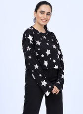 Model wearing a black Selena sweatshirt with silver star prints, showcasing the relaxed fit and long sleeves of this sewing pattern.