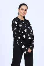 Model wearing a black Selena sweatshirt with silver star prints, showcasing the relaxed fit and long sleeves of this sewing pattern.