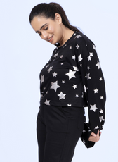 Side view of the Selena sweatshirt in black with silver stars, highlighting the round neck, drop shoulders, and comfortable fit.