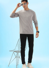 Model wearing a striped men's long sleeve T-shirt with black jeans and sunglasses. A stylish and versatile DIY sewing pattern for everyday wear.