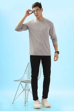 Model wearing a striped men's long sleeve T-shirt with black jeans and sunglasses. A stylish and versatile DIY sewing pattern for everyday wear.