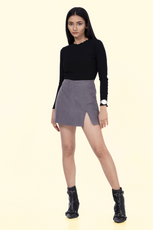 Model wearing the 'Jasmine' skort, a stylish mini skort with an asymmetrical front flap. Perfect for active wear with a chic and modern design.