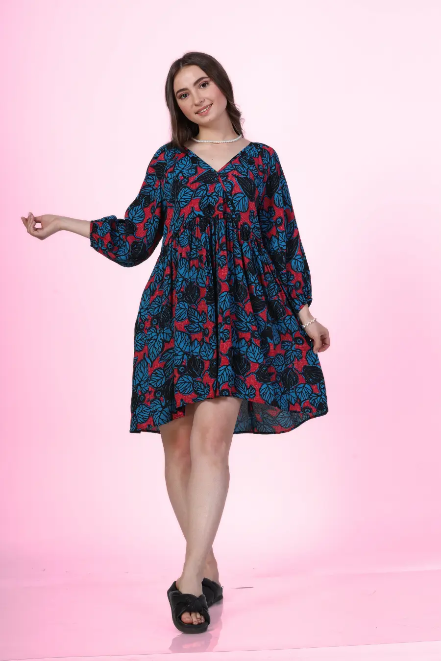 Image of a model wearing a V-neck dress highlighting the flowing lantern sleeves and V-neckline