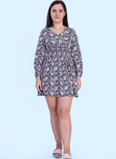 Front view of the Donna Shirred Dress in a floral print. This mini dress features a shirred bodice, long sleeves, and a flared skirt, perfect for any season.