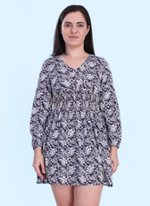 Close-up of the Donna Shirred Dress, highlighting the smocked bodice and long sleeves. A stylish and comfortable mini dress for day or night wear.