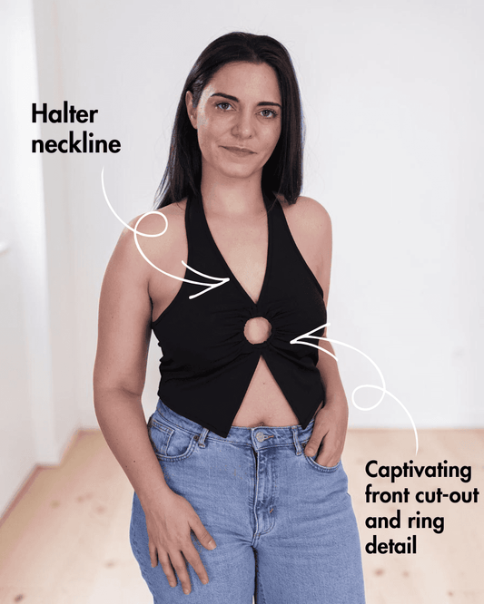 Woman wearing black halter neck crop top with front cut-out and ring detail