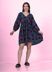 Image of a model wearing a V-neck dress sewed with Winslet's patterns, posing against a pink background.