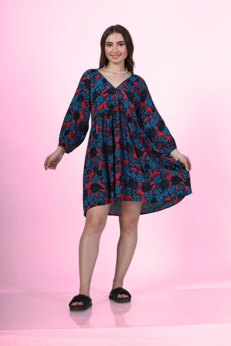 Image of a model wearing a V-neck dress sewed with Winslet's patterns, posing against a pink background.