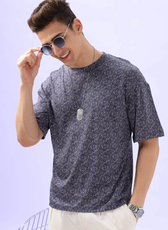 Model adjusting sunglasses while wearing the Men's Oversized T-shirt 'Archie', emphasizing its stylish and laid-back appeal.