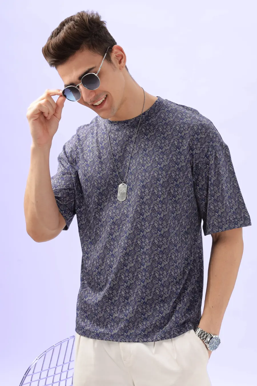 Model adjusting sunglasses while wearing the Men's Oversized T-shirt 'Archie', emphasizing its stylish and laid-back appeal.