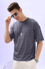 Model adjusting sunglasses while wearing the Men's Oversized T-shirt 'Archie', emphasizing its stylish and laid-back appeal.