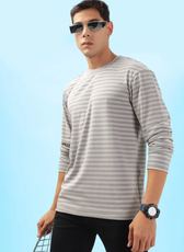 Model posing in a striped men's long sleeve T-shirt sewn from the 'Maddy' pattern. A great DIY project for casual and athleisure looks.
