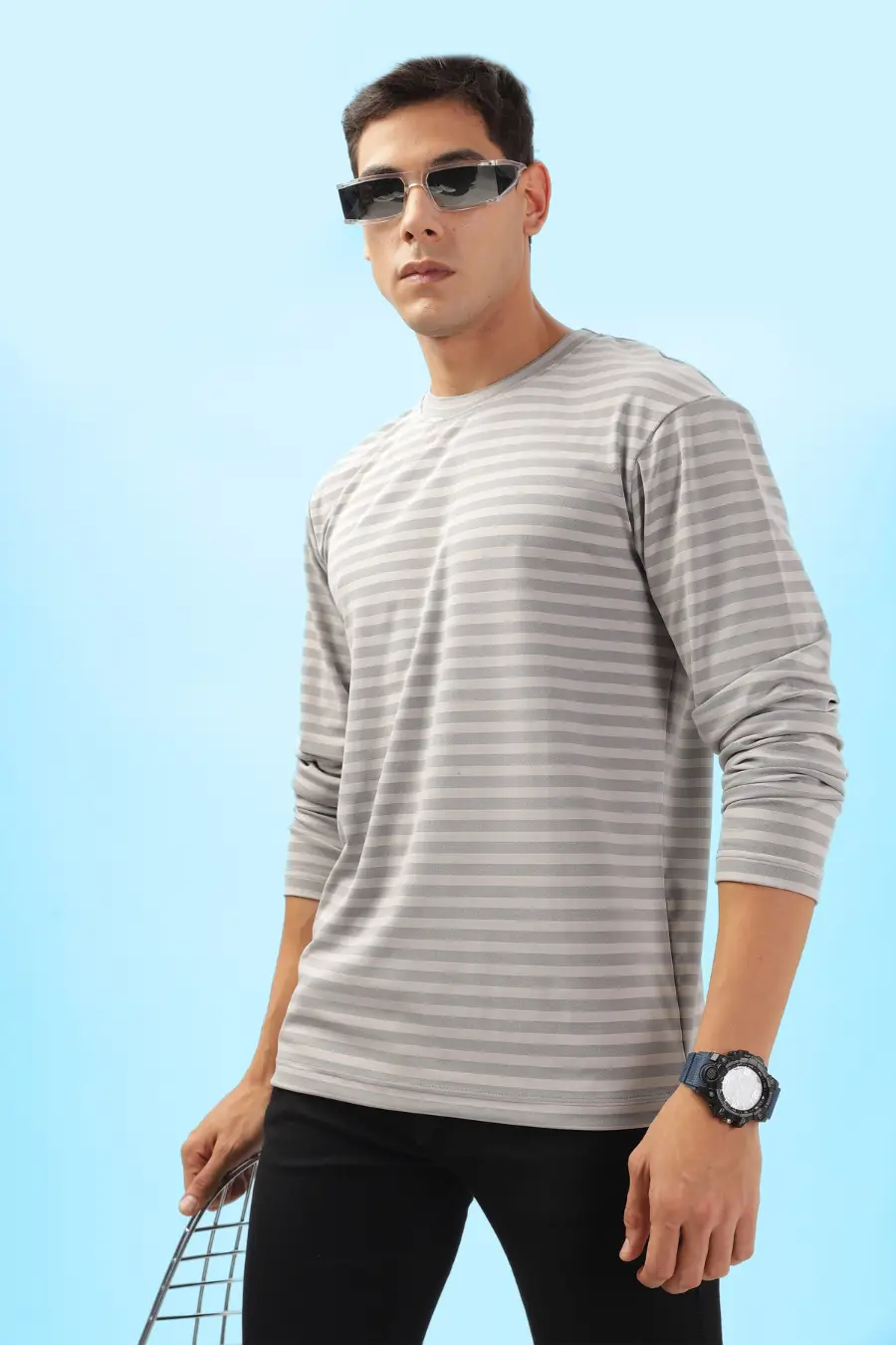 Model posing in a striped men's long sleeve T-shirt sewn from the 'Maddy' pattern. A great DIY project for casual and athleisure looks.