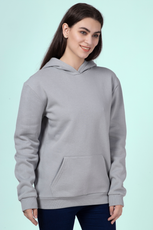 Close-up of a woman wearing a gray hoodie made using the 'Rhea' sewing pattern. Features a kangaroo pocket, ribbed cuffs, and a relaxed fit.