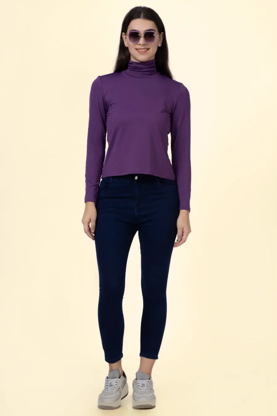 Full-body shot of a model in the 'Diana' turtleneck T-shirt, paired with jeans. A modern and stylish sewing pattern for all sizes.