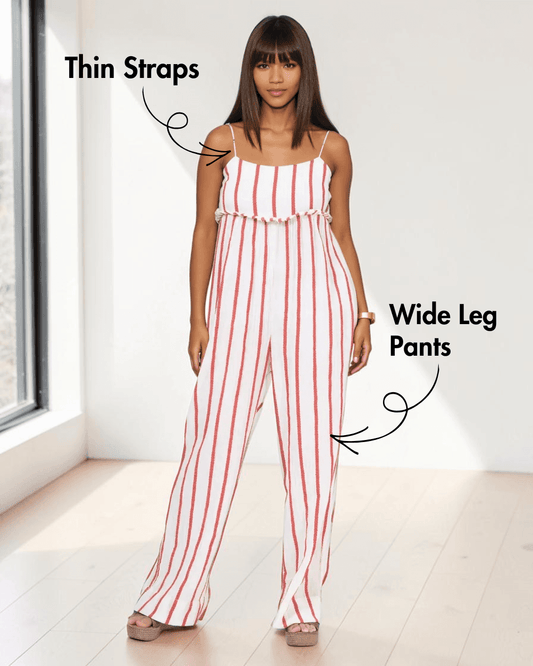 Woman wearing sleeveless striped jumpsuit sewing pattern with thin straps and wide-leg pants, front view
