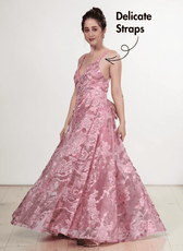 Model wearing pink floral lace evening gown with plunging neckline, flowing gathered skirt, delicate straps, low scoop back, side view