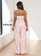 Back view of woman in sleeveless striped jumpsuit with frill detail and wide-leg pants