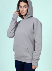 Model wearing a gray hoodie with the hood up, highlighting the spacious and cozy hood design of the 'Rhea' sewing pattern.