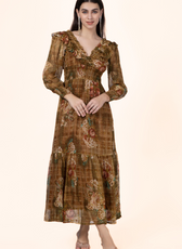 Model wearing a vintage-inspired Daisy Maxi Dress with a floral print, V-neckline, and shirred waist. Perfect for sewing enthusiasts.
