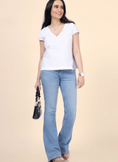 Woman styled in a V-neck relaxed top with side button details, created from Winslet's sewing pattern. A versatile and beginner-friendly sewing project.