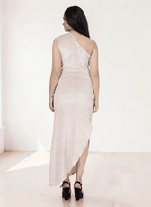 Back view of woman in one shoulder ruched maxi dress with asymmetric hem