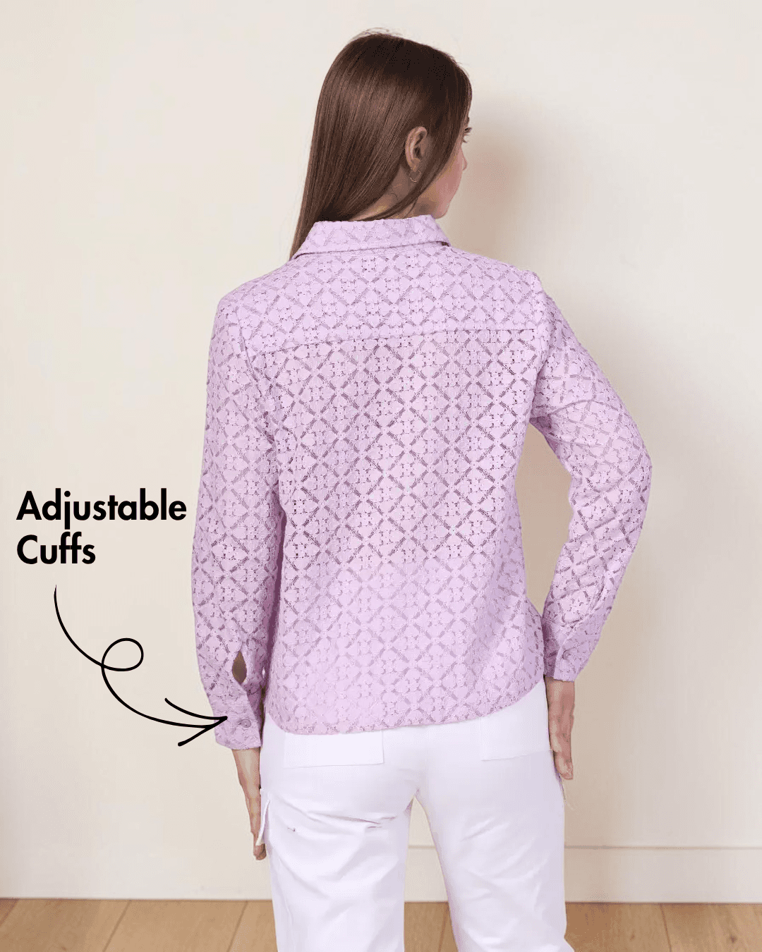Back view of woman in pink lace button-down shirt with white pants, highlighting adjustable cuffs for sewing pattern 'Aspen'