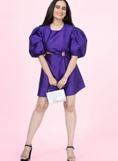 Front view of a model wearing a Cocktail mini dress with ring cutout at waist and voluminous sleeves.
