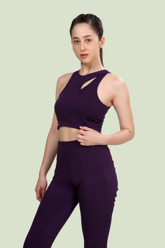 Model wearing Layla cutout sports bra in deep purple. Features a stylish cutout neckline and racerback design, perfect for activewear or casual outfits.