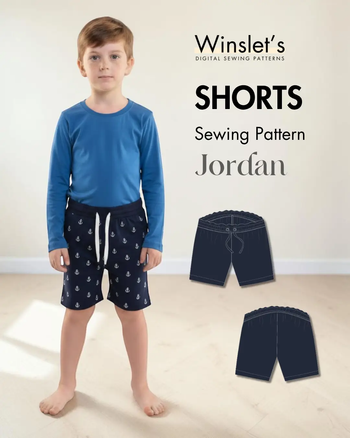 Young boy wearing navy shorts with anchor print, elastic waistband, and drawstring, paired with a blue long-sleeve shirt, casual summer outfit